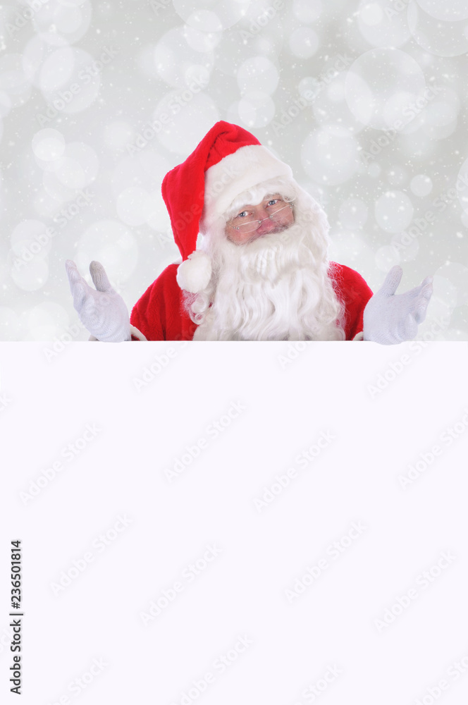 Santa Claus making a gesture with both hands as he stands behind a blank sign Santa Claus making a gesture with both hands as he stands behind a blank sign