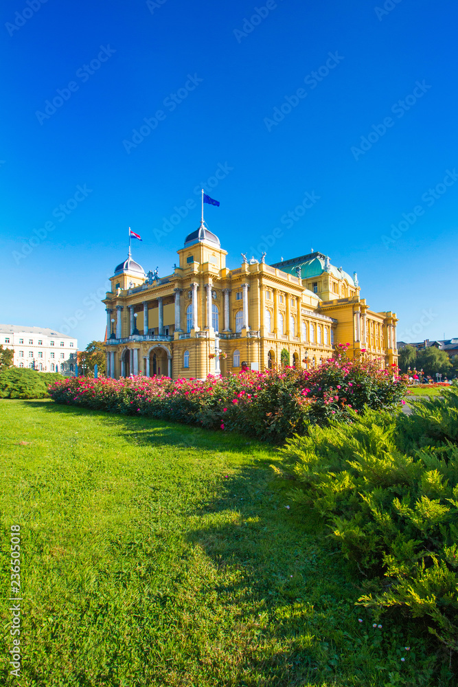      Croatian national theater building and flowers in park in Zagreb, Croatia 