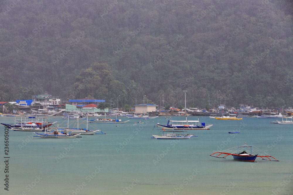 Fishing and tour boats moored under heavy rain. El Nido-Palawan-Philippines-0814