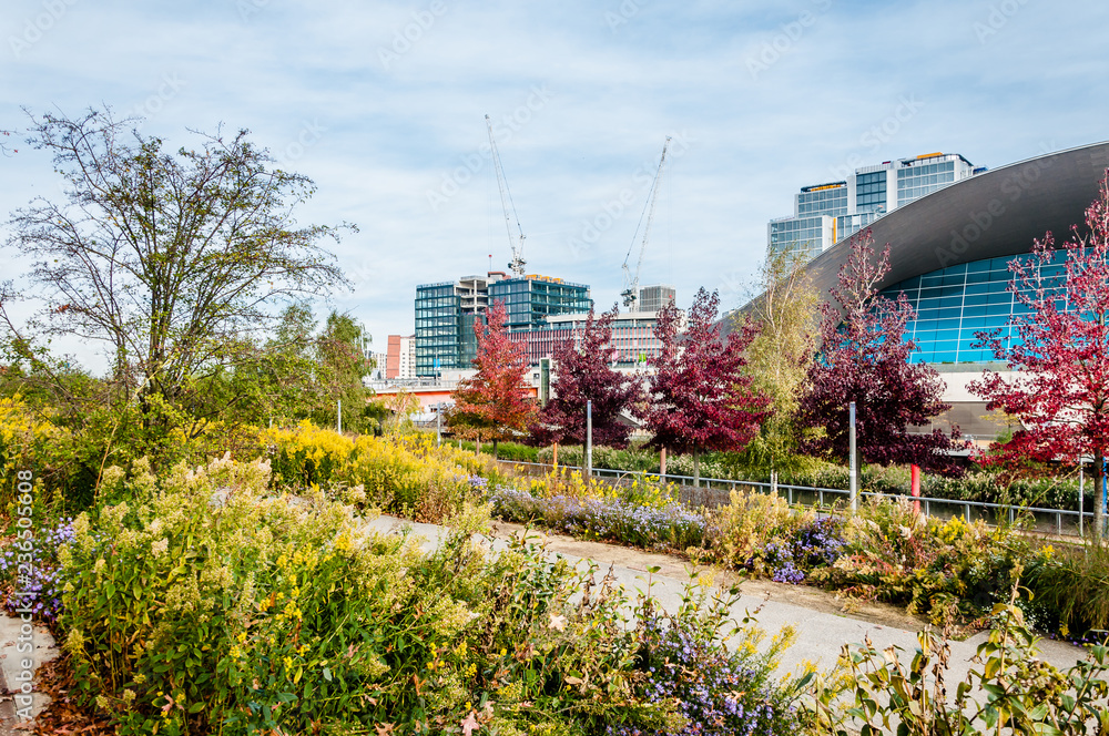 The London Aquatics Centre can be seen with the new development of the International Quarter being built behind it. The London Aquatics Centre can be seen with the new development of the International Quarter being built behind it.