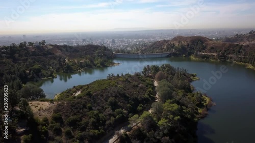 aerial shot circling around hollywood lake and hollywood barrage, with downtown Los Angeles in the background