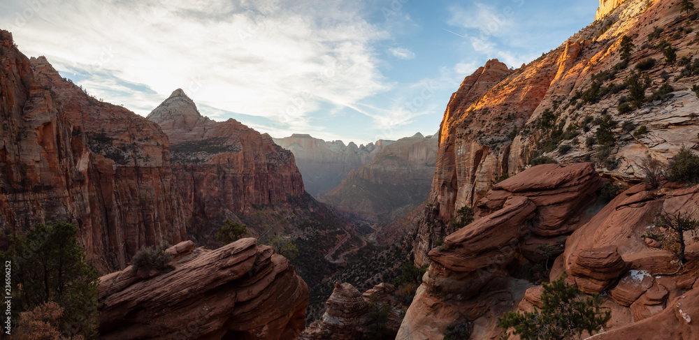 Beautiful aerial panoramic landscape view of a Canyon during a vibrant sunny sunset. Taken in Zion National Park, Utah, United States.