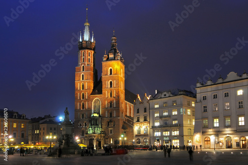 Gothic basilica of Virgin Mary (Kosciol Mariacki) on the main market square (Rynek Glowny) at night, Cracow, Poland.