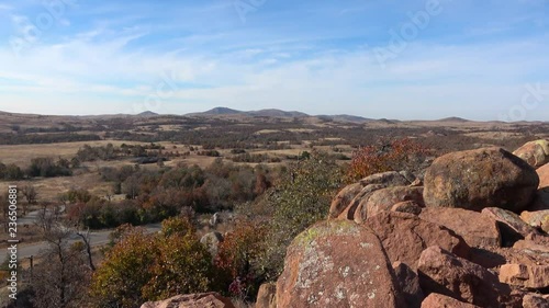 View of landscape with plain and road,  and part of mountain rocks. View from Wichita Mountains.
