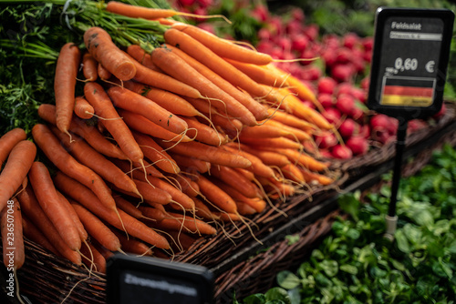 fresh carrot in a bundle on the counter in the biomarket photo