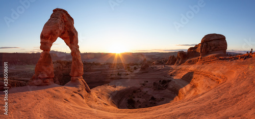 Beautiful panoramic landscape of the unique sandstone rock formation in the desert during a sunny sunset. Taken in Arches National Park, Moab, Utah, United States.
