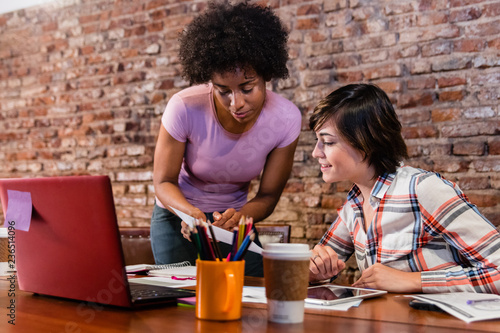 Boss and employee working on business proposal at office