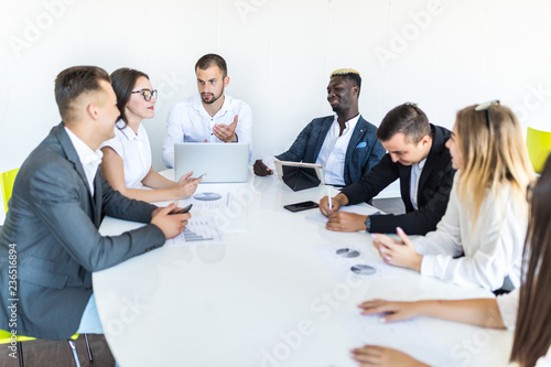 Businesspeople discussing together in conference room during meeting at office. Team work.