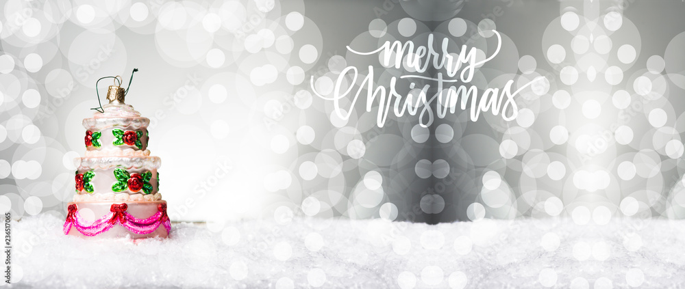 Small heart shaped decoration on snow, against a beautiful holiday inspired background, copy space left Small heart shaped decoration on snow, against a beautiful holiday inspired background, copy space left