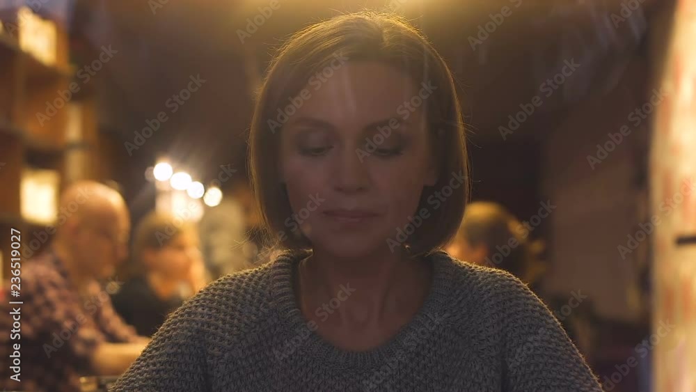 Pretty young woman drinking cappuccino sitting in restaurant, hot beverage Pretty young woman drinking cappuccino sitting in restaurant, hot beverage