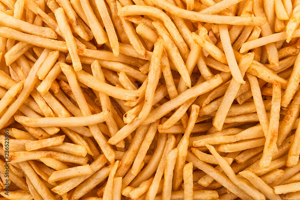 Background of stack of crispy french fries, directly above. Close up. Background of stack of crispy french fries, directly above. Close up.