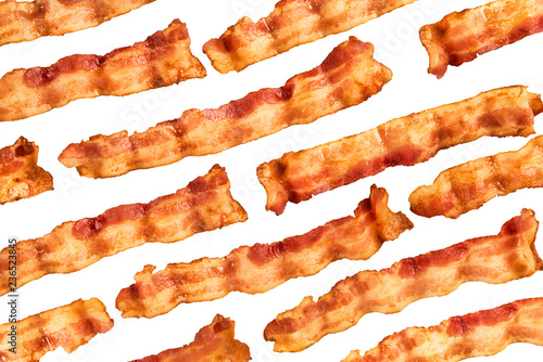 Background of bacon slices disposed in diagonal and isolated on white background. Directly above.