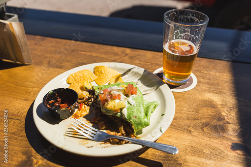 Lunch Plate on Outdoor Table with Burrito and Beer