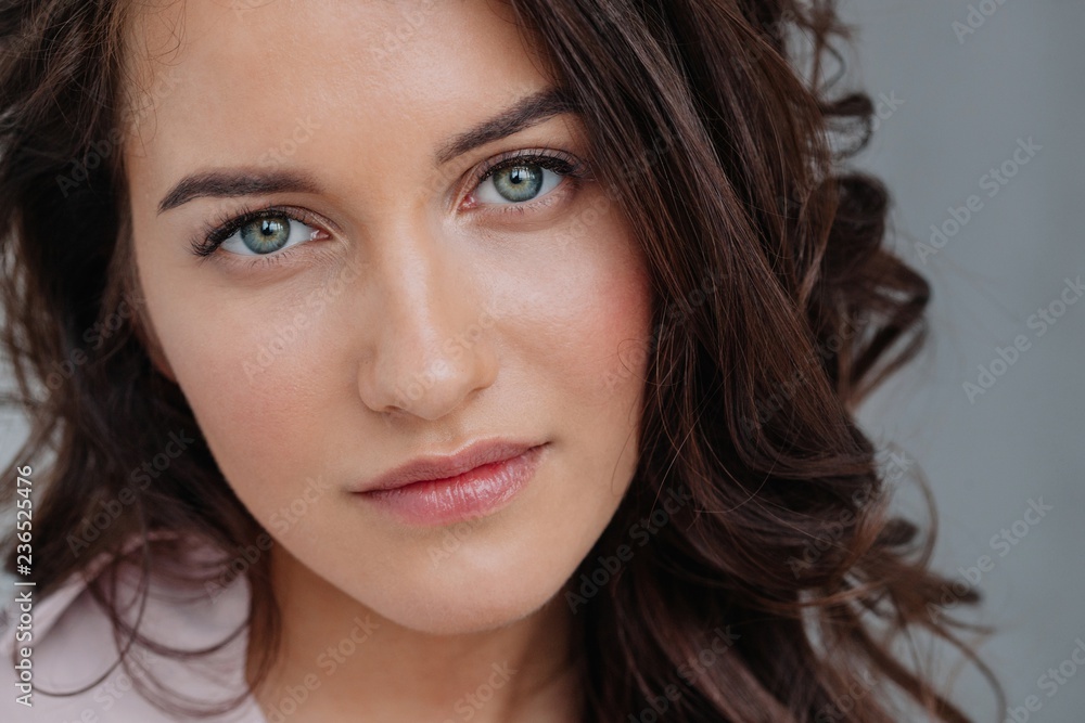 Beauty portrait of attractive young woman looking at camera Beauty portrait of attractive young woman looking at camera