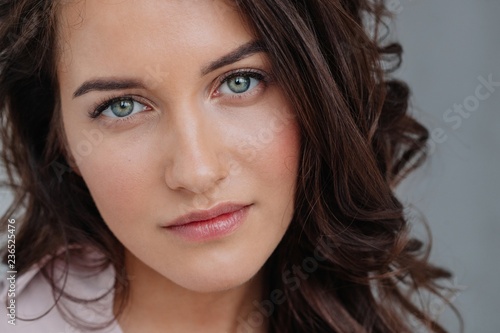 Beauty portrait of attractive young woman looking at camera