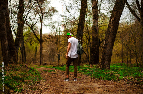 guy with backpack in the woods