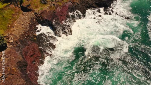 Waves crashing against rocks with spectacular sea sprays. photo