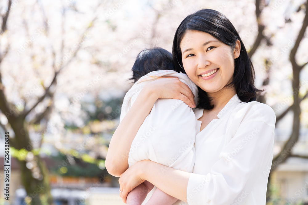 portrait of young asian mother and baby looking cherry blossom portrait of young asian mother and baby looking cherry blossom