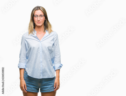 Young beautiful business woman over isolated background with serious expression on face. Simple and natural looking at the camera.