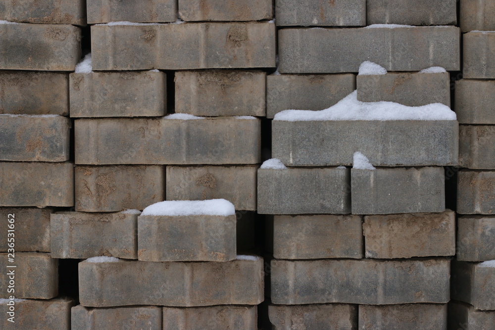 bricks under snow. snow cover stack of brick bricks under snow. snow cover stack of brick