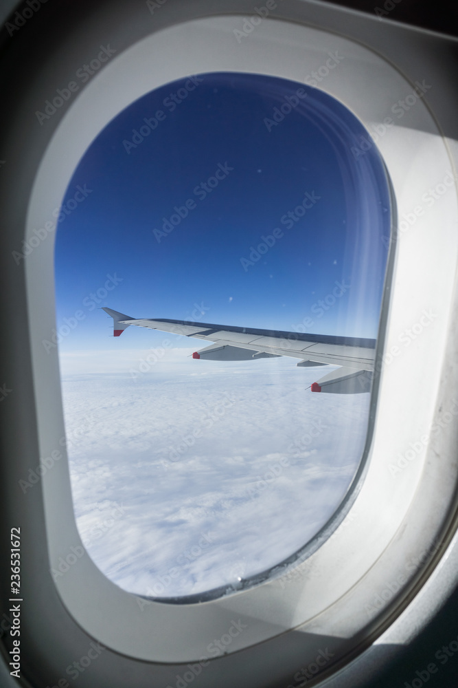 Looking through the window while flying above a sea of clouds Looking through the window while flying above a sea of clouds