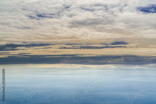 Sunset light illuminating layers of white fluffy clouds