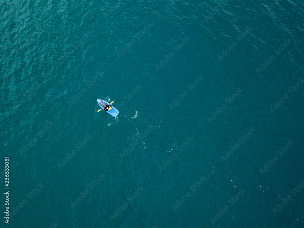 Aerial view to kayaker in blue waters Aerial view to kayaker in blue waters