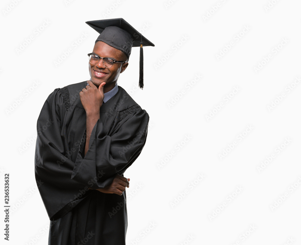 Young graduated african american man over isolated background looking confident at the camera with smile with crossed arms and hand raised on chin. Thinking positive. Young graduated african american man over isolated background looking confident at the camera with smile with crossed arms and hand raised on chin. Thinking positive.