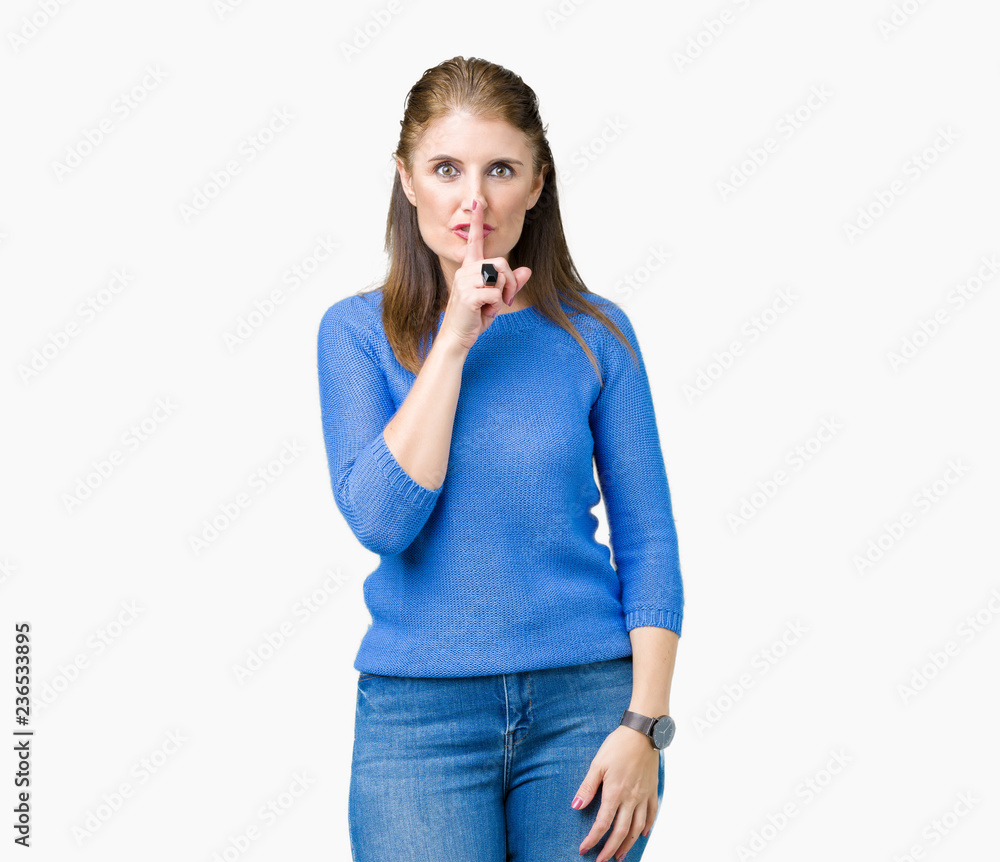 Beautiful middle age mature woman wearing winter sweater over isolated background asking to be quiet with finger on lips. Silence and secret concept. Beautiful middle age mature woman wearing winter sweater over isolated background asking to be quiet with finger on lips. Silence and secret concept.