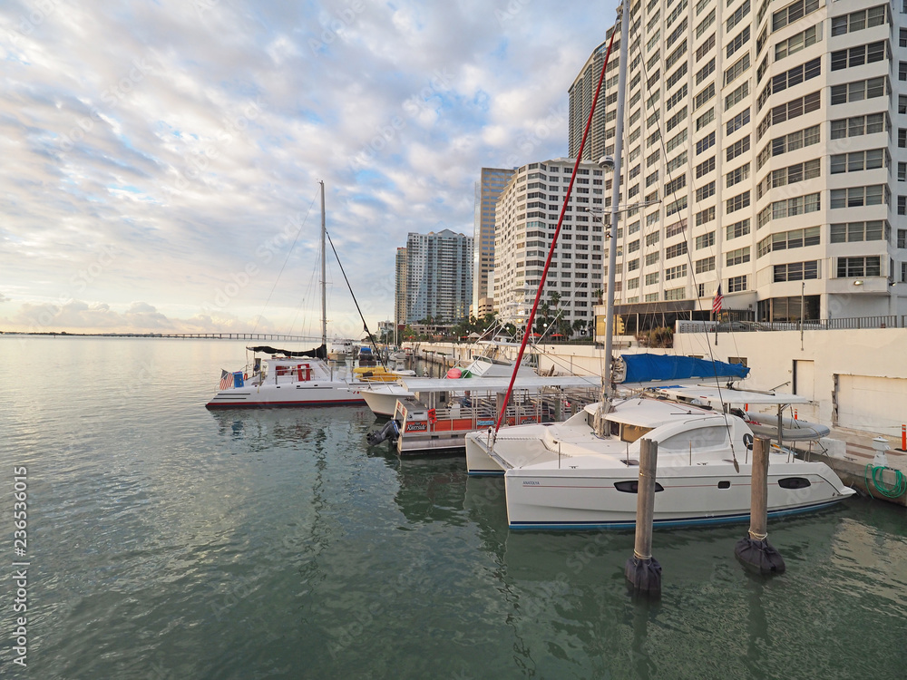 Miami, Florida 11-24-2018 Boats docked in back of residential buildings on Biscayne Bay in early morning light.