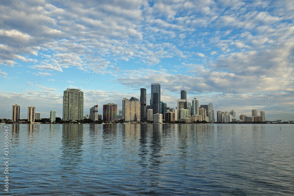 Miami, Florida 11-24-2018 The skyline of the City of Miami, Florida, reflected in the calm water of Biscayne Bay in early morning light.