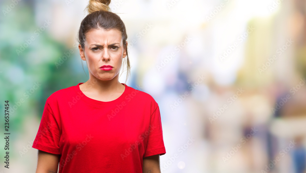 Fototapeta premium Young beautiful woman over isolated background skeptic and nervous, frowning upset because of problem. Negative person.