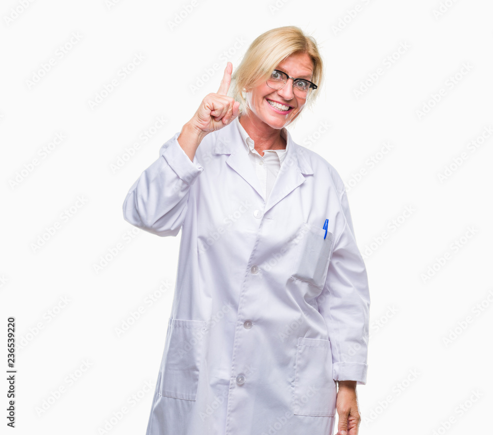 Middle age blonde therapist woman wearing white coat over isolated background pointing finger up with successful idea. Exited and happy. Number one. Middle age blonde therapist woman wearing white coat over isolated background pointing finger up with successful idea. Exited and happy. Number one.