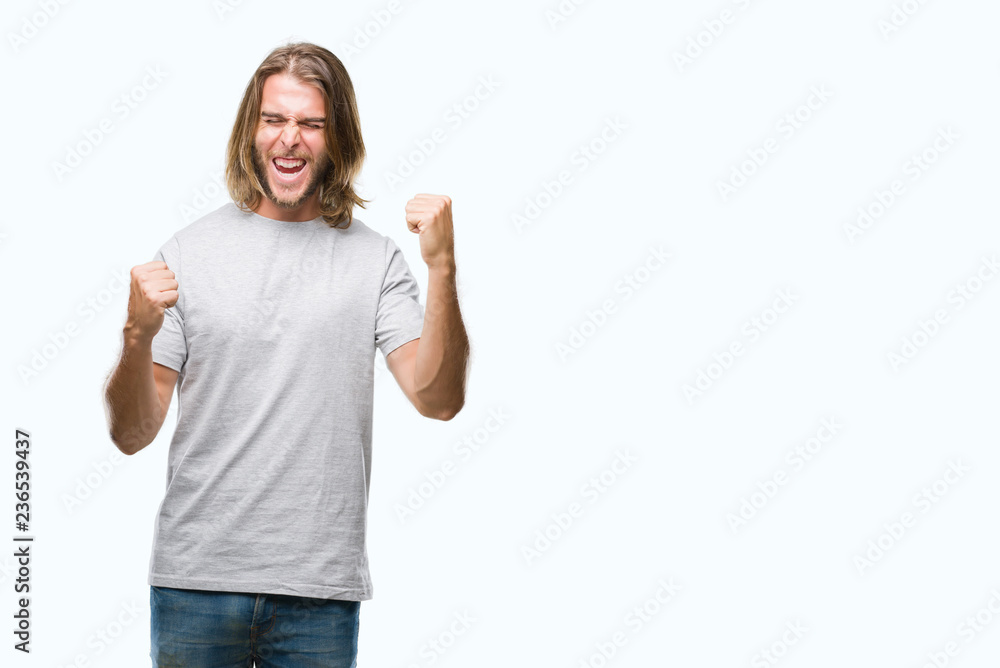 Young handsome man with long hair over isolated background very happy and excited doing winner gesture with arms raised, smiling and screaming for success. Celebration concept. Young handsome man with long hair over isolated background very happy and excited doing winner gesture with arms raised, smiling and screaming for success. Celebration concept.