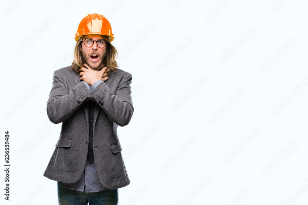 Young handsome architec man with long hair wearing safety helmet over isolated background shouting and suffocate because painful strangle. Health problem. Asphyxiate and suicide concept. Young handsome architec man with long hair wearing safety helmet over isolated background shouting and suffocate because painful strangle. Health problem. Asphyxiate and suicide concept.