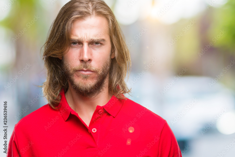 Young handsome man with long hair over isolated background skeptic and nervous, frowning upset because of problem. Negative person. Young handsome man with long hair over isolated background skeptic and nervous, frowning upset because of problem. Negative person.