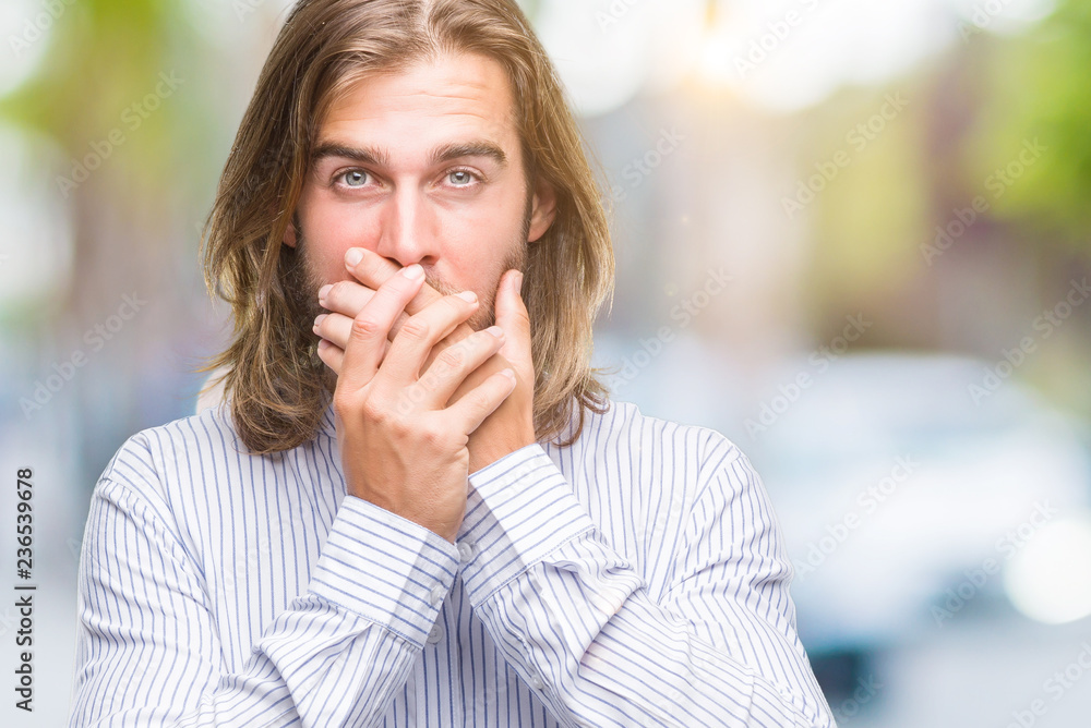 Young handsome man with long hair over isolated background shocked covering mouth with hands for mistake. Secret concept. Young handsome man with long hair over isolated background shocked covering mouth with hands for mistake. Secret concept.