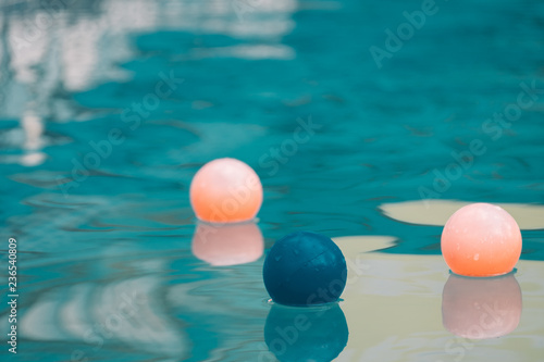 Inflatable colorful ball floating in a swimming pool © Pantira