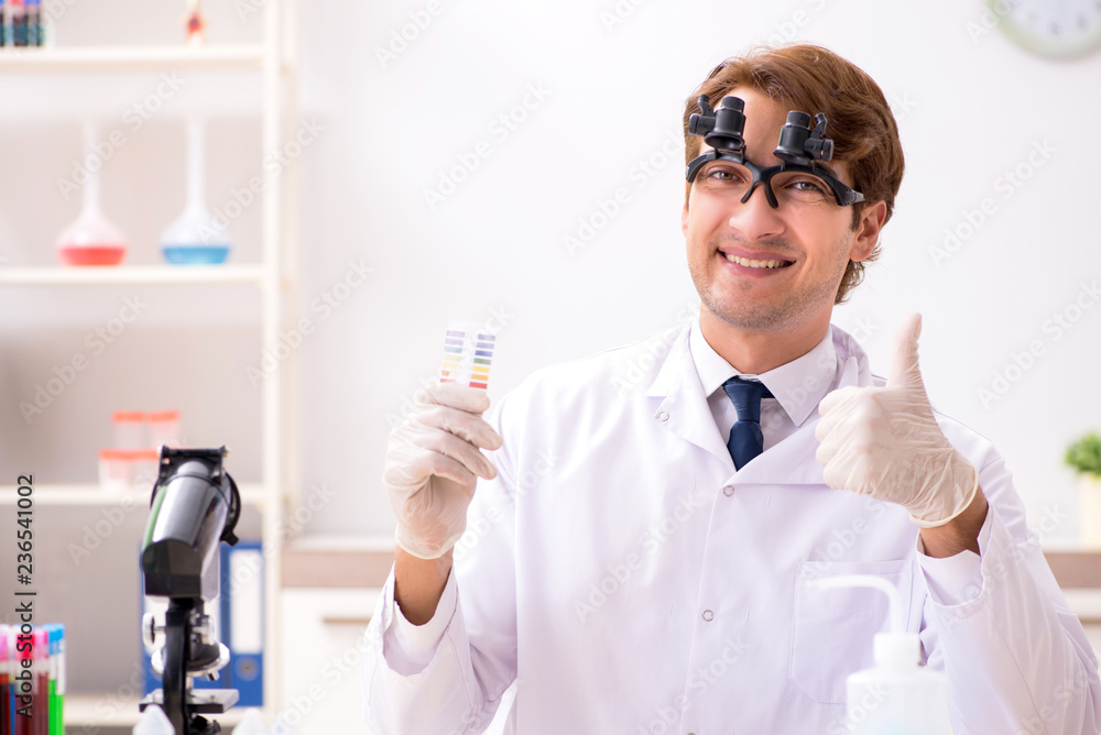 Chemist in the lab checking with ph strips Chemist in the lab checking with ph strips