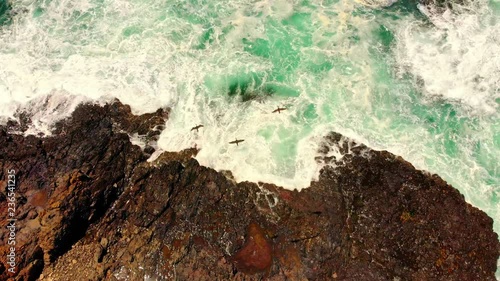 Waves crashing against rocks alaong the coast of Australia photo