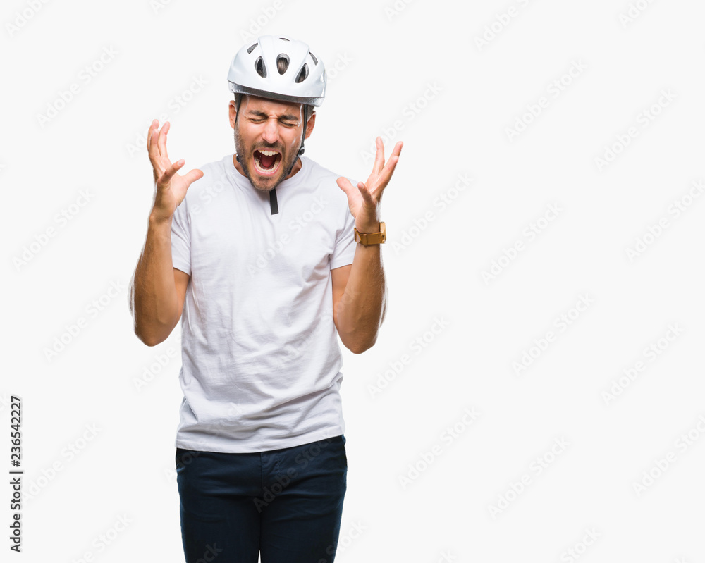 Young handsome man wearing cyclist safety helmet over isolated background celebrating mad and crazy for success with arms raised and closed eyes screaming excited. Winner concept Young handsome man wearing cyclist safety helmet over isolated background celebrating mad and crazy for success with arms raised and closed eyes screaming excited. Winner concept