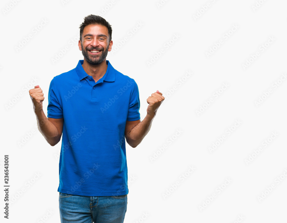 Adult hispanic man over isolated background celebrating surprised and amazed for success with arms raised and open eyes. Winner concept. Adult hispanic man over isolated background celebrating surprised and amazed for success with arms raised and open eyes. Winner concept.