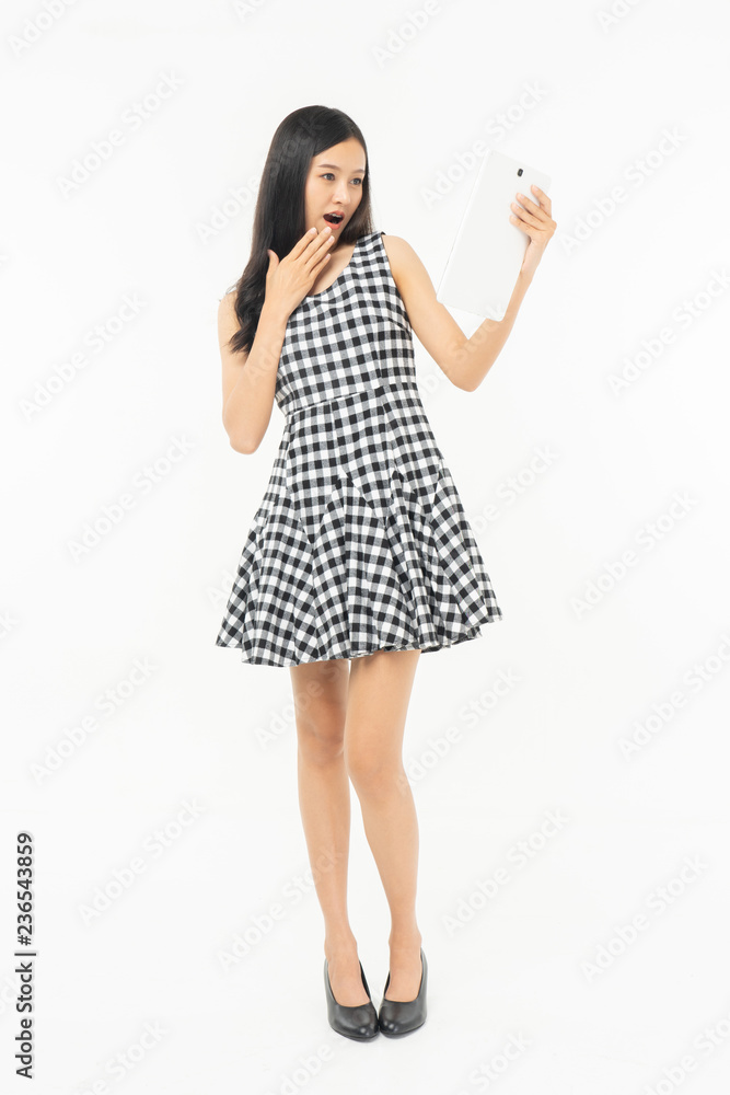 smiling beautiful  asian woman holding tablet computer isolated on a white background.