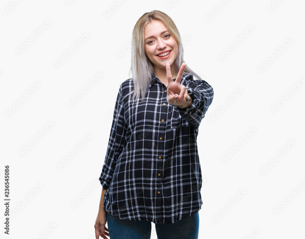 Young blonde woman over isolated background smiling with happy face winking at the camera doing victory sign. Number two. Young blonde woman over isolated background smiling with happy face winking at the camera doing victory sign. Number two.