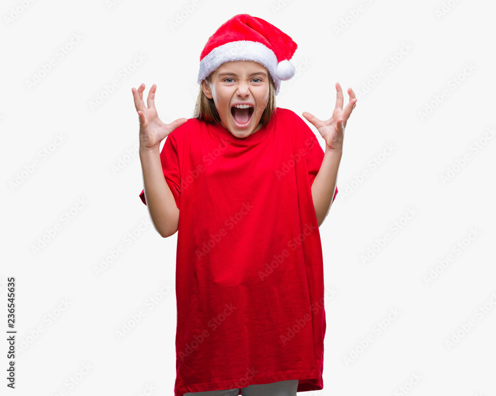 Young beautiful girl wearing christmas hat over isolated background celebrating mad and crazy for success with arms raised and closed eyes screaming excited. Winner concept Young beautiful girl wearing christmas hat over isolated background celebrating mad and crazy for success with arms raised and closed eyes screaming excited. Winner concept
