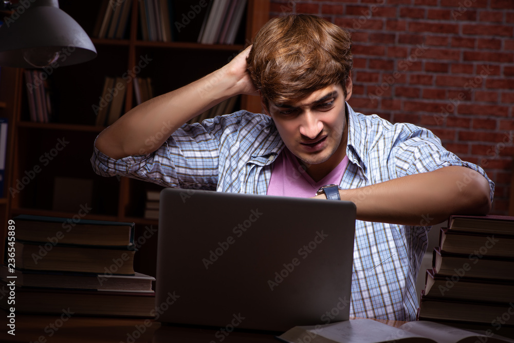 Young handsome student preparing for exams at night Young handsome student preparing for exams at night