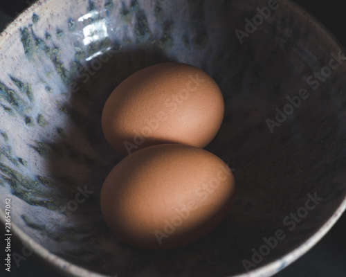 2 Brown eggs in ceramic bowl 
