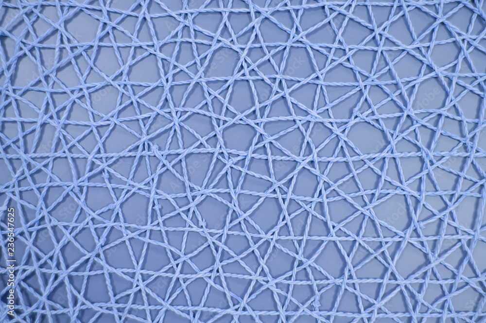 Fototapeta premium woven mesh of artificial material on blue background