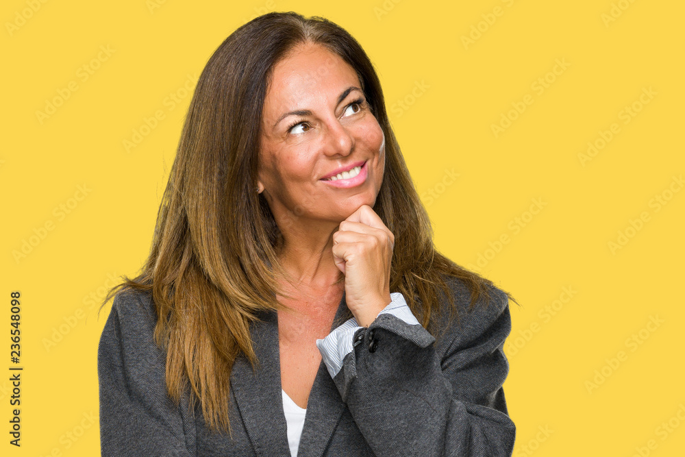 Middle age adult woman wearing oversize boyfriend jacket over isolated background with hand on chin thinking about question, pensive expression. Smiling with thoughtful face. Doubt concept. Middle age adult woman wearing oversize boyfriend jacket over isolated background with hand on chin thinking about question, pensive expression. Smiling with thoughtful face. Doubt concept.