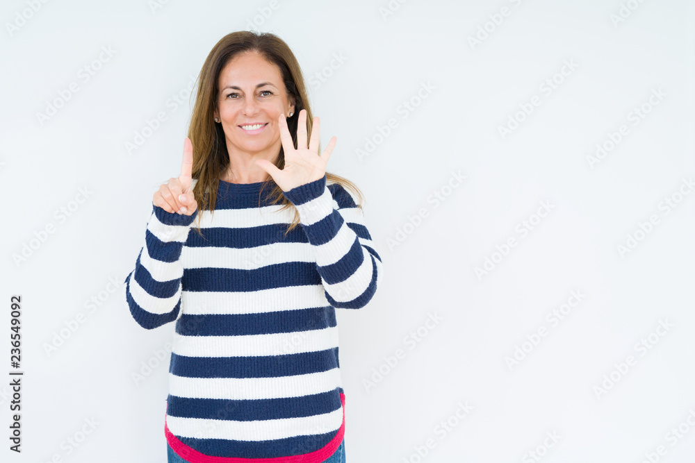 Beautiful middle age woman wearing navy sweater over isolated background showing and pointing up with fingers number six while smiling confident and happy. Beautiful middle age woman wearing navy sweater over isolated background showing and pointing up with fingers number six while smiling confident and happy.